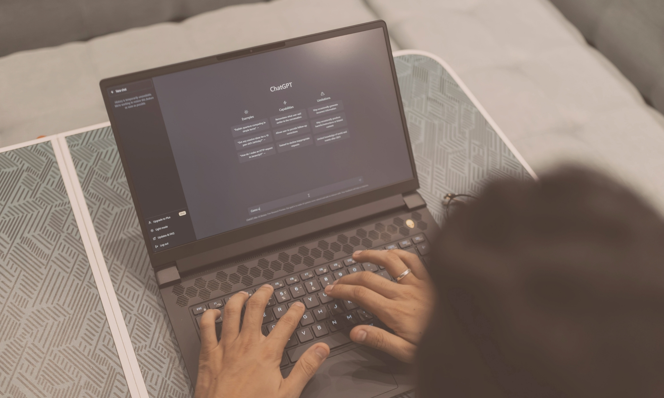 Person typing on a laptop with the ChatGPT homepage open, exploring AI search tools